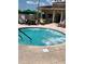 Outdoor spa with spa rules sign, lounge chairs and patio furniture at 1903 Canterbury Ln # B2, Sun City Center, FL 33573