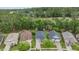 An aerial view looking down at several homes and their rooflines near a wooded area at 19529 Lily Pond Ct, Brooksville, FL 34601