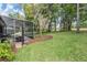 View of the screened-in lanai extends to the backyard, which has plenty of room for recreation and relaxation at 19529 Lily Pond Ct, Brooksville, FL 34601