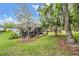 The screen enclosed patio looks out over the lush yard, full of mature trees at 19529 Lily Pond Ct, Brooksville, FL 34601