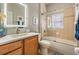 This bathroom offers a tub-shower combination, and a vanity with wooden cabinetry at 19529 Lily Pond Ct, Brooksville, FL 34601