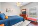 This bedroom is furnished with a queen bed, dresser, vanity and pink bench at 19529 Lily Pond Ct, Brooksville, FL 34601