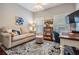 Cozy room with comfortable furniture, including a couch, desk, and decorative rug at 19529 Lily Pond Ct, Brooksville, FL 34601