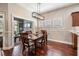 The dining area features a modern chandelier and access to the outdoor patio at 19529 Lily Pond Ct, Brooksville, FL 34601