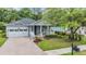 Inviting single-Gathering home featuring a brick driveway, manicured lawn, and charming front porch at 19529 Lily Pond Ct, Brooksville, FL 34601