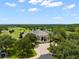 Beautiful home surrounded by lush greenery and a well-manicured lawn with golf course views at 19529 Lily Pond Ct, Brooksville, FL 34601