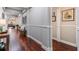 Elegant hallway featuring hardwood floors, neutral walls, and decorative trim at 19529 Lily Pond Ct, Brooksville, FL 34601