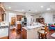 Bright open kitchen featuring a breakfast bar, stainless steel appliances, and hardwood floors at 19529 Lily Pond Ct, Brooksville, FL 34601