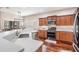 Modern kitchen with stainless steel appliances, quartz countertops, and hardwood floors at 19529 Lily Pond Ct, Brooksville, FL 34601