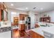 Well-lit kitchen with stainless steel appliances, wooden cabinets, and a view into the dining area at 19529 Lily Pond Ct, Brooksville, FL 34601