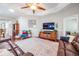 Spacious living room with ceiling fan, hardwood floors, and a leather sectional at 19529 Lily Pond Ct, Brooksville, FL 34601