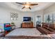 Well-lit living room with ceiling fan and large windows at 19529 Lily Pond Ct, Brooksville, FL 34601