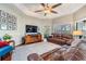 Bright living room with a ceiling fan and hardwood floors at 19529 Lily Pond Ct, Brooksville, FL 34601