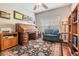 Well-lit office room with traditional wood desk, a comfortable chair and custom built-in shelving at 19529 Lily Pond Ct, Brooksville, FL 34601