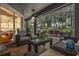 The screened-in lanai offers an entertainment area with an outdoor table and chairs and a comfortable seating area at 19529 Lily Pond Ct, Brooksville, FL 34601