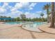 Inviting swimming pool featuring a tanning deck with lounge chairs, an awning, and lush tropical landscaping at 19529 Lily Pond Ct, Brooksville, FL 34601