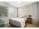 Cozy bedroom featuring a neutral palette and decorative accent wall at 28853 Seedling St, Wesley Chapel, FL 33543