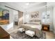 Cozy bedroom featuring a barn door entry to the en suite bathroom and sunlit windows with shutter blinds at 28853 Seedling St, Wesley Chapel, FL 33543