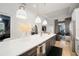 Bright kitchen features a large island with quartz countertops, modern lighting, and stainless steel appliances at 28853 Seedling St, Wesley Chapel, FL 33543