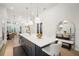 Gourmet kitchen featuring a large island with seating, pendant lights and stainless steel appliances at 28853 Seedling St, Wesley Chapel, FL 33543