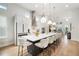 Kitchen showcasing island with bar seating, white cabinets, stainless steel appliances, and pendant lights at 28853 Seedling St, Wesley Chapel, FL 33543