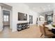 Open concept living area with wood floors and view of kitchen with bar seating and pendant lights at 28853 Seedling St, Wesley Chapel, FL 33543