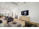 Bright living room offers wood floors, comfortable seating, and an open layout flowing into the kitchen at 28853 Seedling St, Wesley Chapel, FL 33543