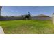 Expansive backyard featuring a well-maintained lawn and wood privacy fence at 2933 Maiden Grass Isle, Wesley Chapel, FL 33543