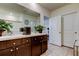 Well decorated bathroom featuring double sinks, tiled floors, and a large mirror at 2933 Maiden Grass Isle, Wesley Chapel, FL 33543