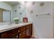 Well-lit bathroom with double vanity, framed mirror and modern faucets at 2933 Maiden Grass Isle, Wesley Chapel, FL 33543