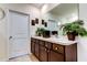 Bathroom featuring double sinks, under-cabinet storage, and neutral tile flooring at 2933 Maiden Grass Isle, Wesley Chapel, FL 33543