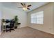 Bright bedroom with a large window, plush carpet, and a dedicated workspace at 2933 Maiden Grass Isle, Wesley Chapel, FL 33543