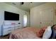 Comfortable bedroom with a wall-mounted TV and lots of natural light at 2933 Maiden Grass Isle, Wesley Chapel, FL 33543
