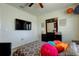 Comfortable bedroom with TV, statement decor and a large dresser at 2933 Maiden Grass Isle, Wesley Chapel, FL 33543