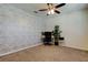 Cozy bedroom with brick accent wall, plush carpet, and a dedicated workspace at 2933 Maiden Grass Isle, Wesley Chapel, FL 33543
