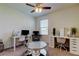 Bedroom featuring two white desks and a ceiling fan at 2933 Maiden Grass Isle, Wesley Chapel, FL 33543