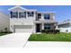 Charming two-story home with a two-car garage and a well-maintained lawn at 2933 Maiden Grass Isle, Wesley Chapel, FL 33543