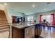 Bright kitchen with granite island, stainless appliances, and dining area at 2933 Maiden Grass Isle, Wesley Chapel, FL 33543