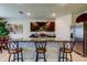 Kitchen island with granite counters, seating, and stainless-steel appliances, creating a functional cooking space at 2933 Maiden Grass Isle, Wesley Chapel, FL 33543