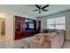 Inviting living room with a large entertainment center, comfortable seating, and plenty of natural light at 2933 Maiden Grass Isle, Wesley Chapel, FL 33543