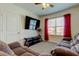 Inviting living room with TV, ceiling fan, and plush seating at 2933 Maiden Grass Isle, Wesley Chapel, FL 33543