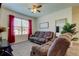 Comfortable living room features cozy seating and natural light at 2933 Maiden Grass Isle, Wesley Chapel, FL 33543