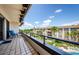 Balcony with tiled flooring, black rails, and a view of the community below, including palm trees and a pool at 3021 Countryside Blvd # 45A, Clearwater, FL 33761