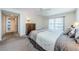 Comfortable bedroom with a ceiling fan, carpeted floors, and a view of the hallway at 3021 Countryside Blvd # 45A, Clearwater, FL 33761
