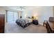 Cozy bedroom with carpeted floors, a ceiling fan, and a sliding glass door that lets in plenty of natural light at 3021 Countryside Blvd # 45A, Clearwater, FL 33761