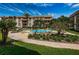 Inviting community pool surrounded by mature trees, lush landscaping, and comfortable lounge chairs, perfect for relaxation at 3021 Countryside Blvd # 45A, Clearwater, FL 33761