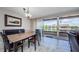 Dining room features a sliding glass door to the balcony and faces the living room at 3021 Countryside Blvd # 45A, Clearwater, FL 33761