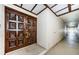 Ornate, solid wood entry door, building hallway, and storage closet at 3021 Countryside Blvd # 45A, Clearwater, FL 33761