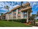 Exterior elevation of a multi-story building with a well-manicured lawn, landscaping and palm trees at 3021 Countryside Blvd # 45A, Clearwater, FL 33761