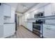 White kitchen offering modern appliances, ample counter space, and overhead lighting at 3021 Countryside Blvd # 45A, Clearwater, FL 33761